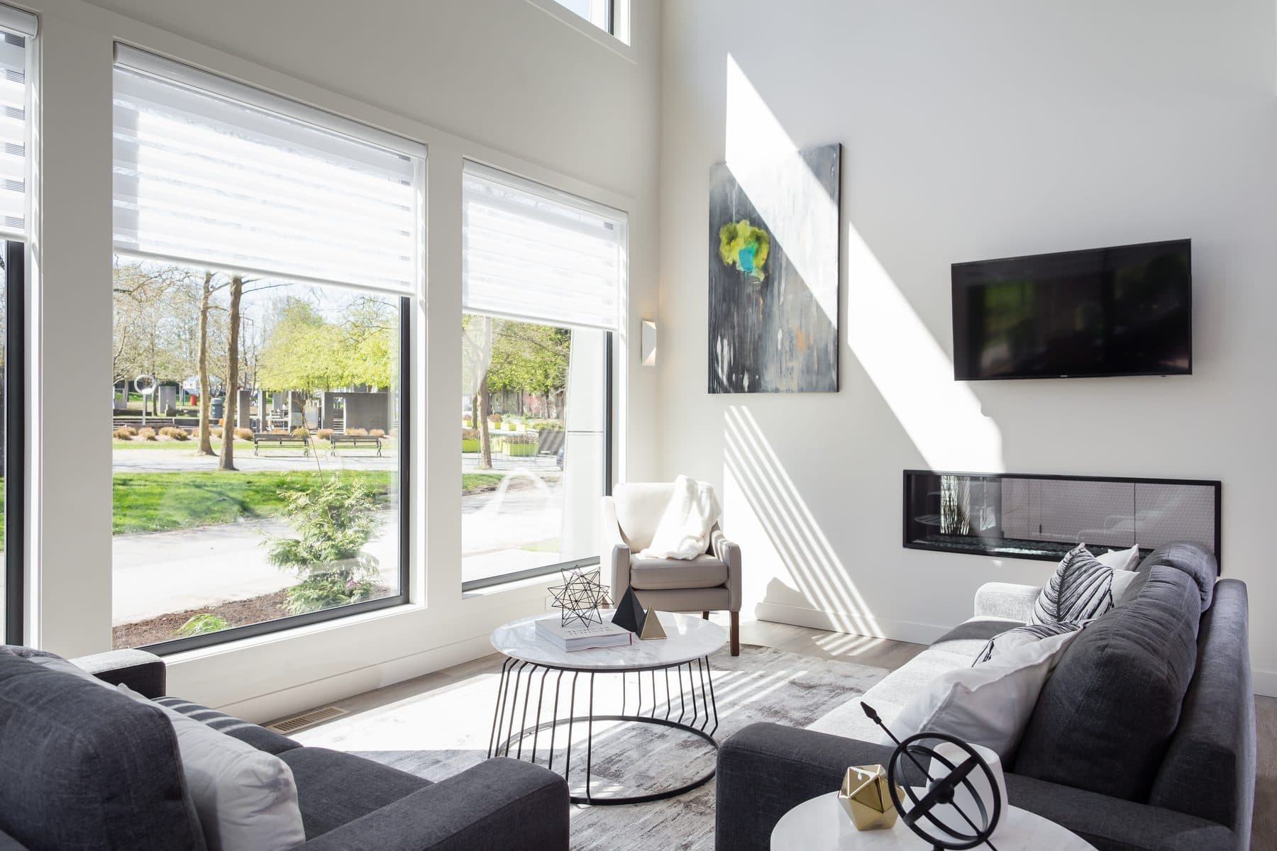 Montage Designer Shades partially raised in a bright living room